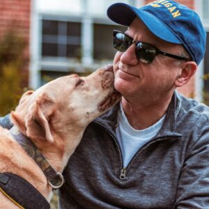 Pet Dog Licking Face of Man