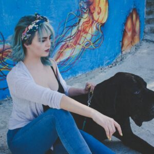 woman sitting beside dog