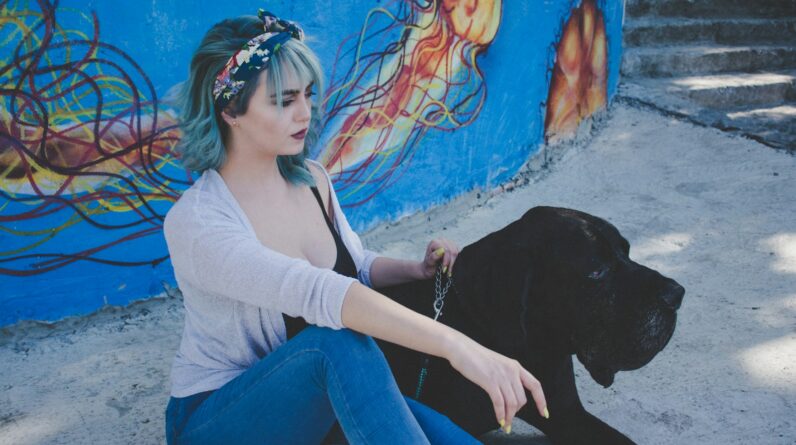 woman sitting beside dog