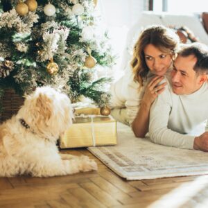 Couple Lying on a Carpet Near their Dog
